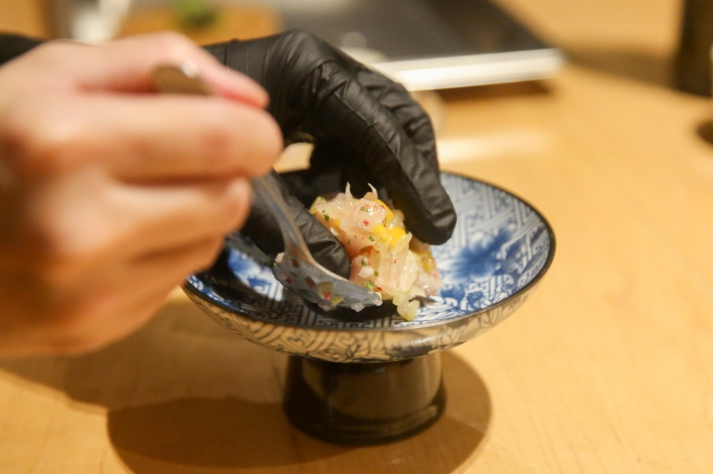 277508 The Japanese yellowtail dish being plated. — Picture by Choo Choy May