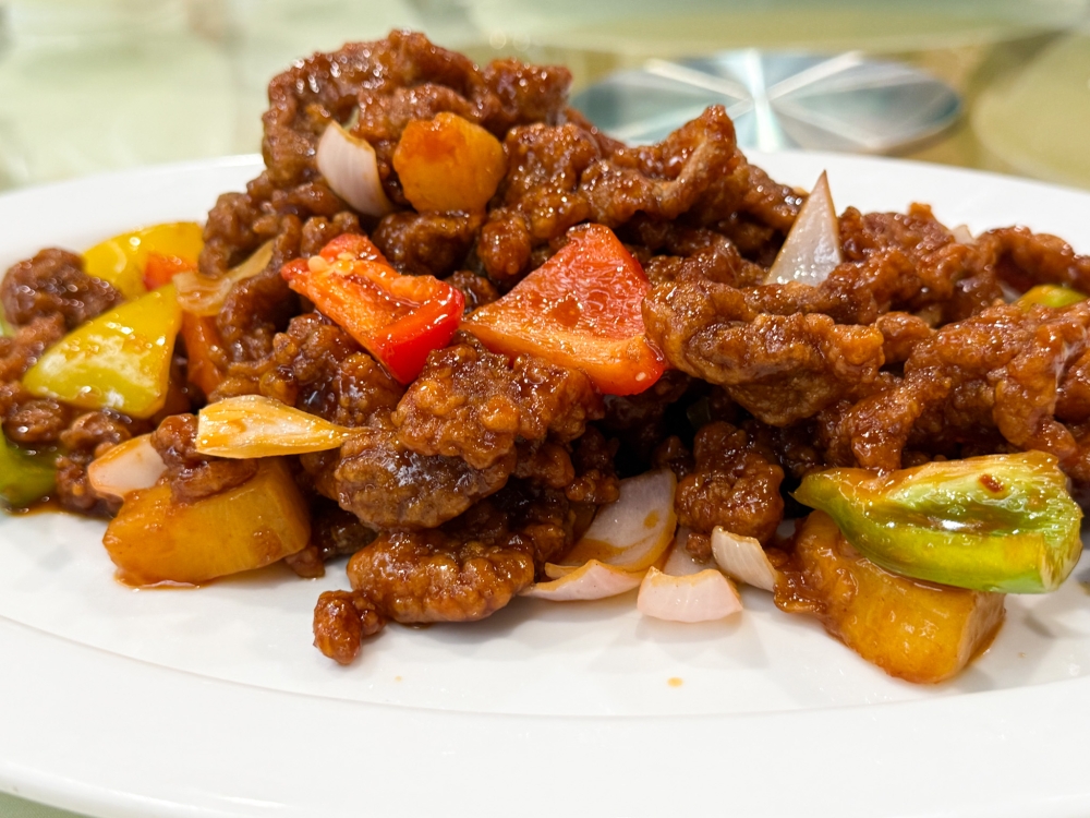 278020 Sweet Sour Pork is served with crunchy thin slices composed with Iberian black pork just coated with a tangy sauce that keeps the crunch even after sitting on the table for some time. — Picture by Lee Khang Yi