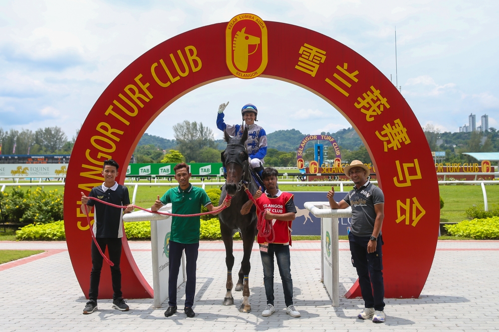 A victorious jockey celebrates with his team at the Selangor Turf Club. — Picture by Yusof Mat Isa