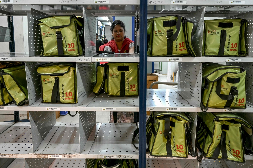 278995 A rider arrives to collect a customer’s order for delivery at a BigBasket dark store in Mumbai March 21, 2025. — AFP pic