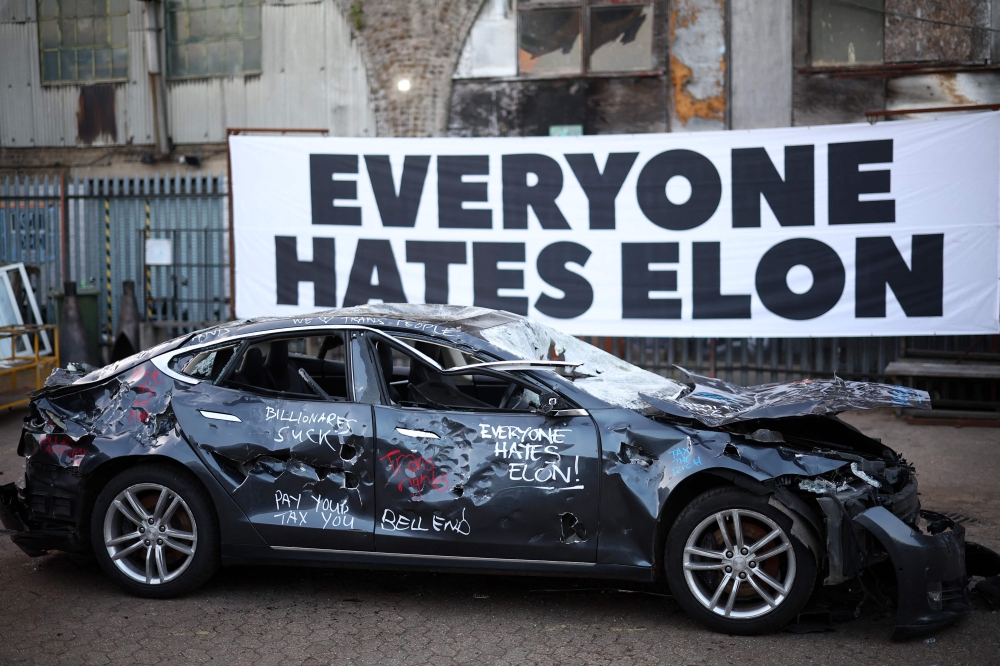 279336 A Tesla car is pictured after being smashed-up at an anti Elon Musk protest, in south London on April 10, 2025. — AFP pic