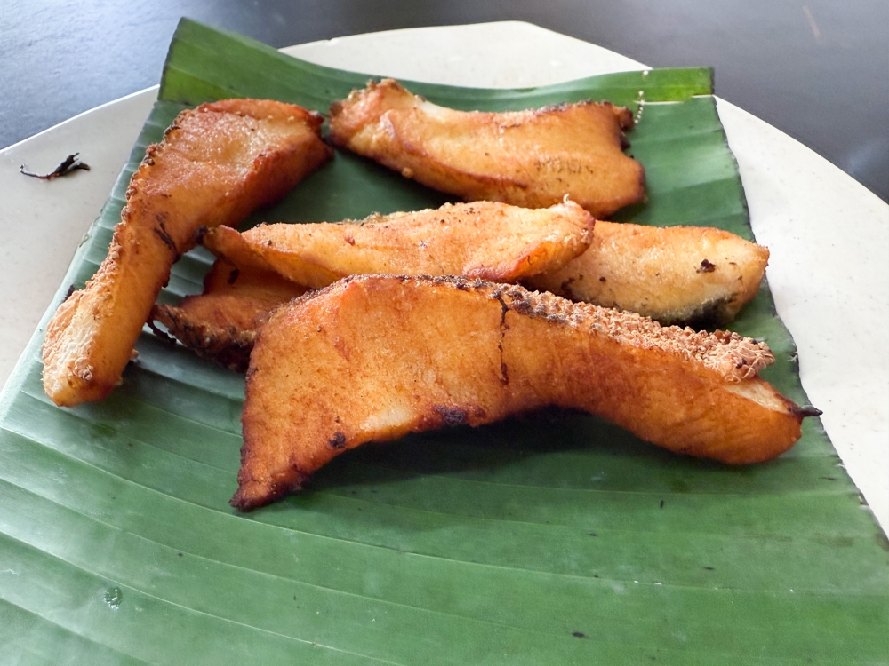 Toman or snakehead fish is often avoided as it has many bones but this fried version is boneless with flaky flesh. — Picture by Lee Khang Yi