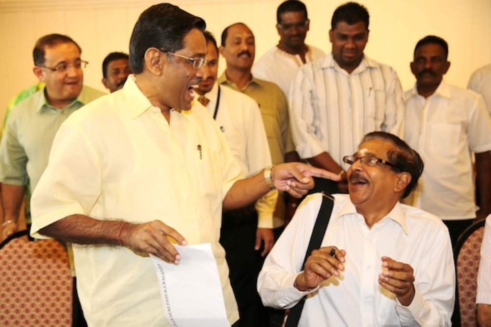 279716 Datuk Seri Dr S.Subramaniam (left) and Datuk Seri G.Palanivel (sitting) sharing a light moment in 2013 before their rift in 2015. — Picture by Choo Choy May