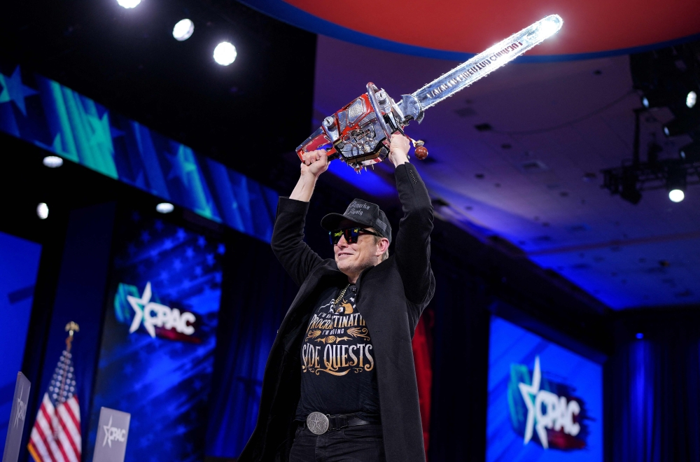 279745 CEO of Tesla and SpaceX Elon Musk wields a chainsaw as he leaves the stage at the Conservative Political Action Conference (CPAC) at the Gaylord National Resort Hotel And Convention Center on February 20, 2025 in Oxon Hill, Maryland. — AFP pic