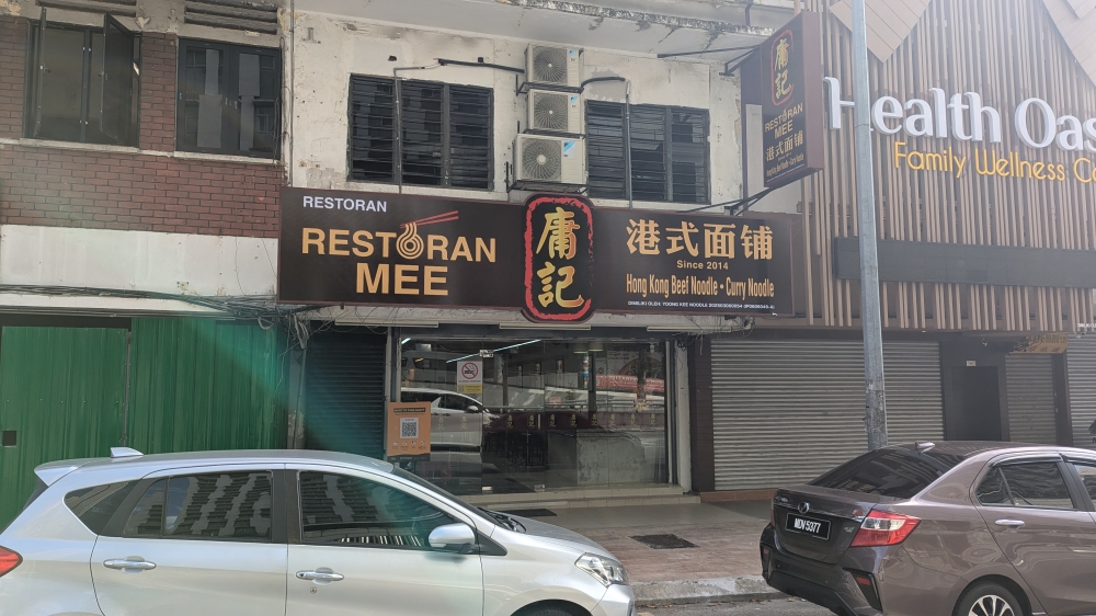 Look for the black sign next to the Healthland massage parlour. — Picture by Ethan Lau