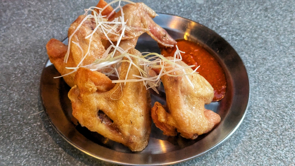Every bar has chicken wings, but not every bar has a dipping sauce like this. — Picture by Ethan Lau