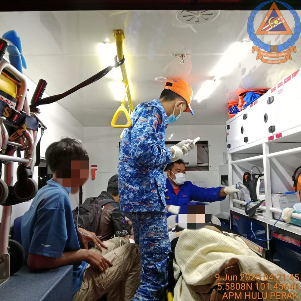 First responders providing emergency treatment to several people injured in the UPSI bus-MPV collision on the East-West Highway in Banun, Gerik on June 9, 2025. — Bernama pic