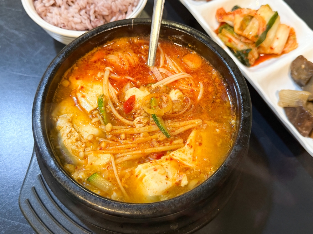 Pork Soft Tofu Soup isn’t fiery hot but a slightly sweeter broth that pairs well with the soft beancurd, enoki mushrooms and minced pork. — Picture by Lee Khang Yi