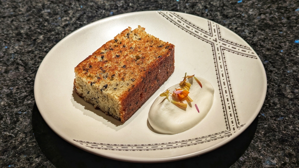 Black sesame cake with ‘crème Chantilly’ on the side. — Picture by Ethan Lau