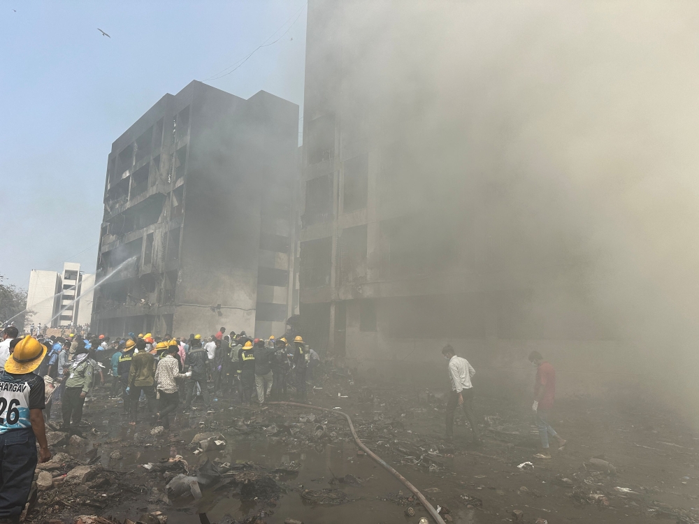 Rescue team members work as smoke rise at the crash site where an Air India plane crashed in Ahmedabad, India, June 12, 2025. — Reuters pic