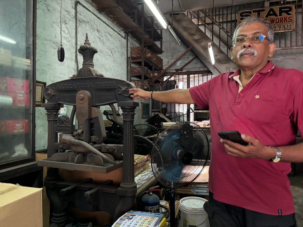 269248-1 Veeramani with the Alexandra press, which is believed to be more than 120 years old. — Picture by John Bunyan
