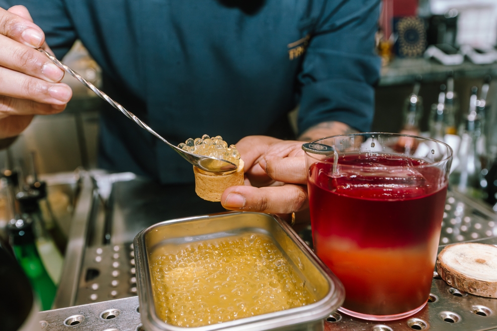 270534-2 Trigona honey ‘caviar’ being portioned out for an order of Bloom, made with Herradura Blanco tequila, pink dragonfruit, ginger beer, Trigona honey liqueur and Trigona honey caviar. — Picture by Raymond Manuel