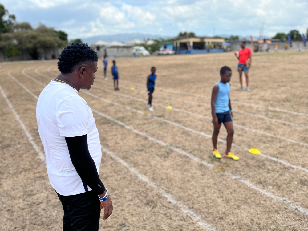 272002-1 Coach Shanti Blake (left) watches children compete at the Richmond Park Sports Complex in Kingston April 5, 2025. — AFP pic