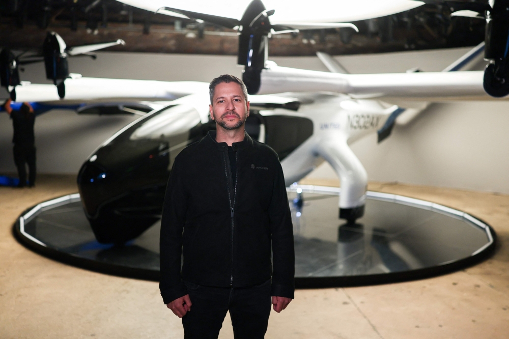 ARCHER CEO Adam Goldstein poses before the Midnight eVTOL aircraft in New York City on April 17, 2025. Archer brought a prototype version of its Midnight aircraft to the Big Apple Thursday to mark the announcement. — AFP pic