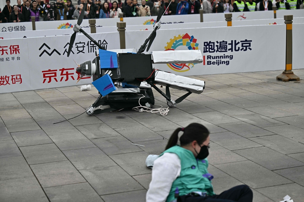 272118-3 A robot loses control as it takes part in a half marathon race against humans in Beijing, China on April 19, 2025. — AFP pic