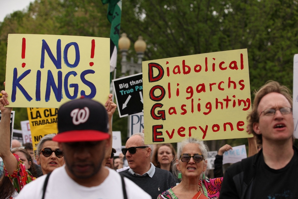 People protest against U.S. President Donald Trump, tariffs, deportations, a variety of other policies, and Elon Musk outside the White House, in Washington, U.S., April 19, 2025. — Reuters pic
