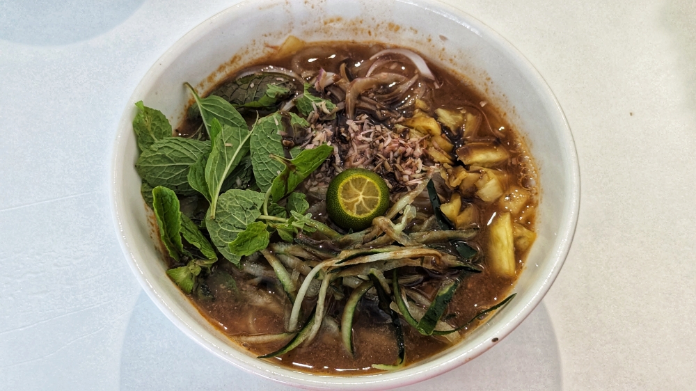Home style ‘laksa’ here is a tasty ‘asam laksa’. — Picture by Ethan Lau