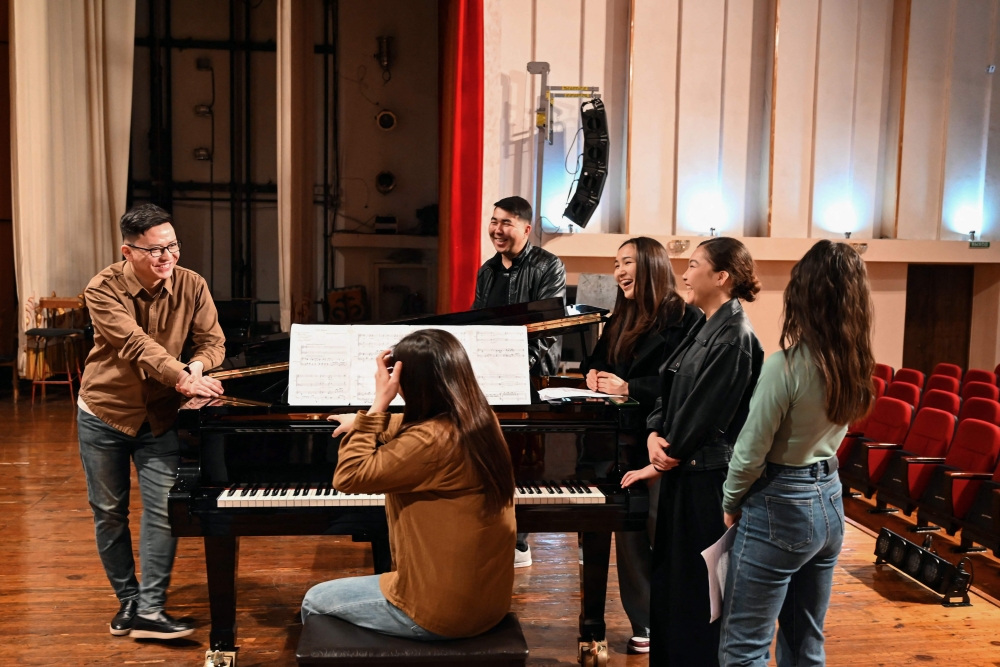 Nurzhyguit Moldoyar (left), singer, composer and student at the K. Moldobasanov Kyrgyz National Conservatory, who participates in a competition to create a new national anthem for Kyrgyzstan, together with fellow musicians and collaborators performs his composition he submitted to the contest, in Bishkek April 5, 2025. — AFP pic
