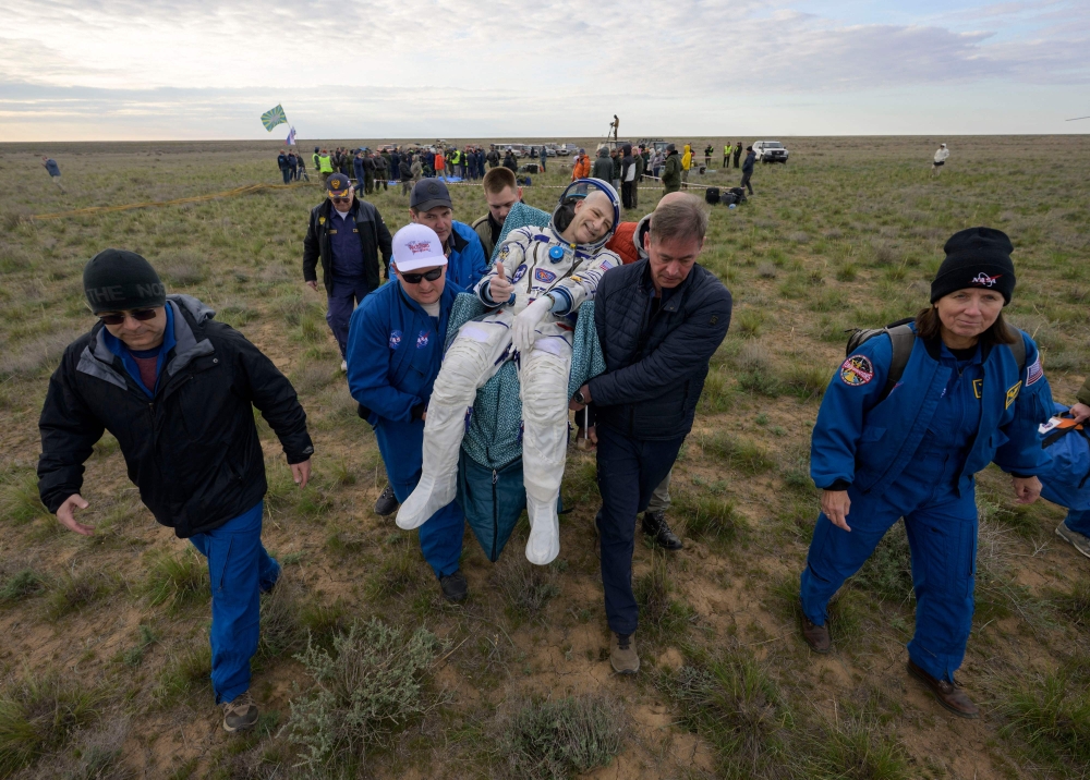Nasa astronaut Don Pettit (centre)  being carried to a medical tent shortly after he, and Roscosmos cosmonauts Alexey Ovchinin and Ivan Vagner landed in their Soyuz MS-26 spacecraft near the town of Zhezkazgan, Kazakhstan on April 20, 2025. — AFP pic