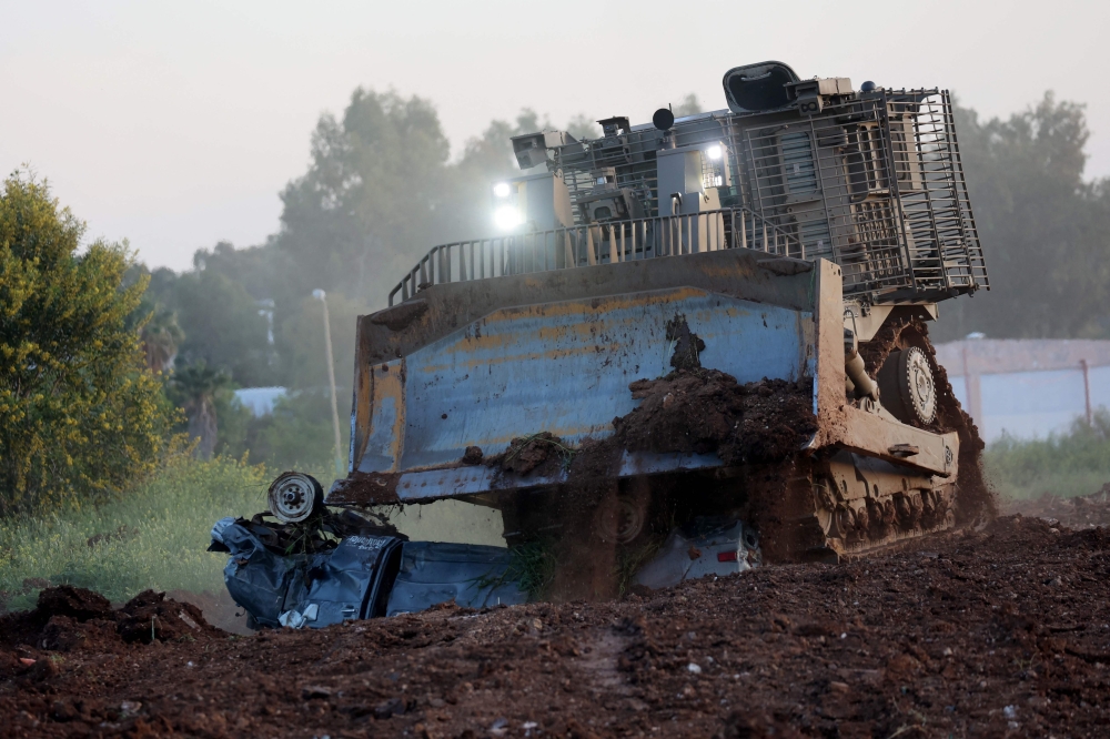 272397 An unmanned D9 bulldozer destroys a vehicle during a demonstration to the press at the Israel Aerospace Industries (IAI) quarters near Tel Aviv on March 26, 2025. — AFP pic
