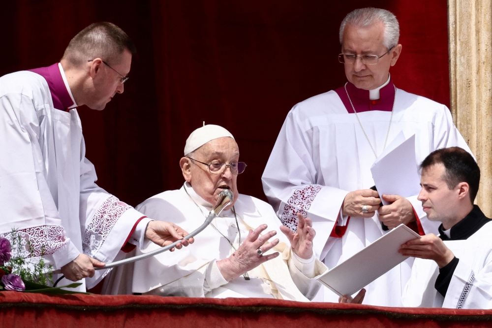 Pope Francis speaks from a balcony on the day of the ‘Urbi et Orbi’ (to the city and to the world) message, at St. Peter's Square, on Easter Sunday, in the Vatican April 20, 2025. — Reuters pic