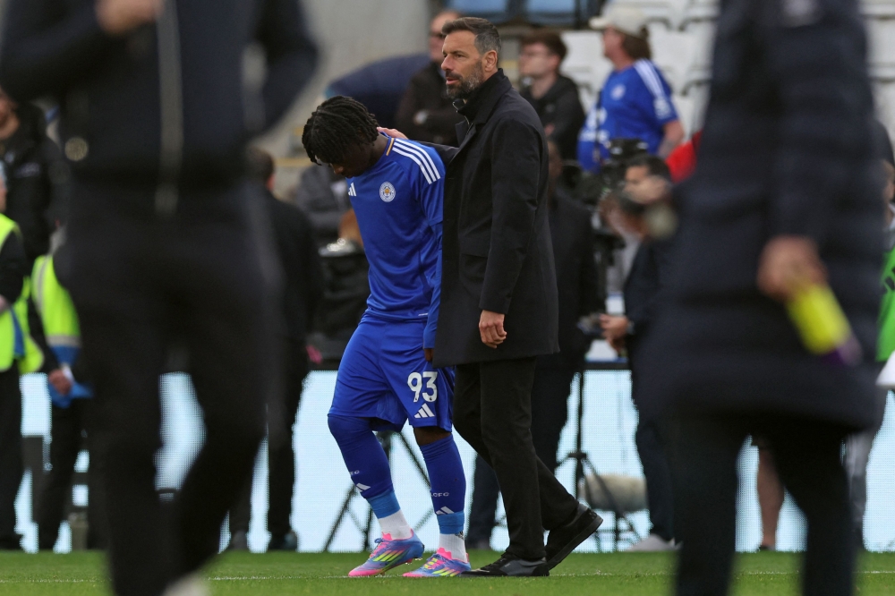 272465 Leicester City's Dutch manager Ruud van Nistelrooy (R) consoles Leicester City's English midfielder #93 Jeremy Monga (left) on the pitch after the English Premier League football match between Leicester City and Liverpool at King Power Stadium in Leicester, central England on April 20, 2025. Leicester were relegated from the Premier League after a 1-0 defeat to Liverpool. — AFP pic