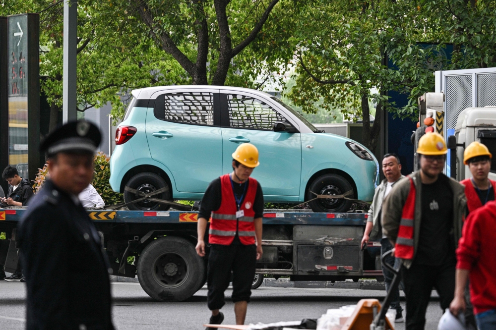 272548 A Wuling Motors car is transported to the National Exhibition and Convention Centre to be displayed for the 21st Shanghai International Automobile Industry Exhibition in Shanghai April 21, 2025. — AFP pic