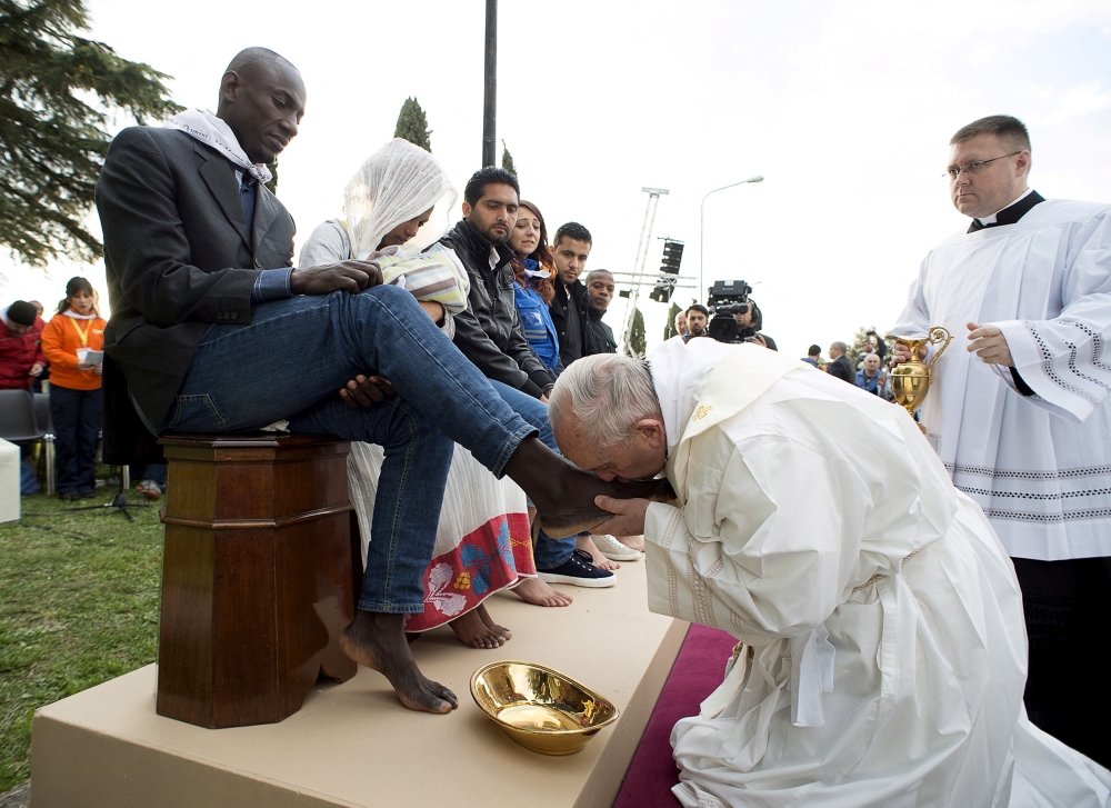 272572 Pope Francis kisses the foot of a refugee during the foot-washing ritual at the Castelnuovo di Porto refugees centre near Rome, Italy, March 24, 2016. — Osservatore Romano/Vatican Media handout pic via Reuters