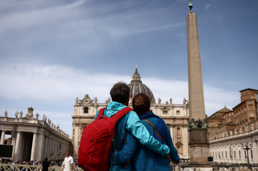 272612 People hug in St. Peter's Square, after the death of Pope Francis was announced by the Vatican in a video statement, at the Vatican, April 21, 2025. — Reuters pic