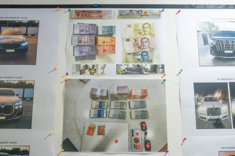 272722 A display showing cash and vehicles seized during Ops Northern Star in Kuala Lumpur April 22, 2025. — Picture by Raymond Manuel