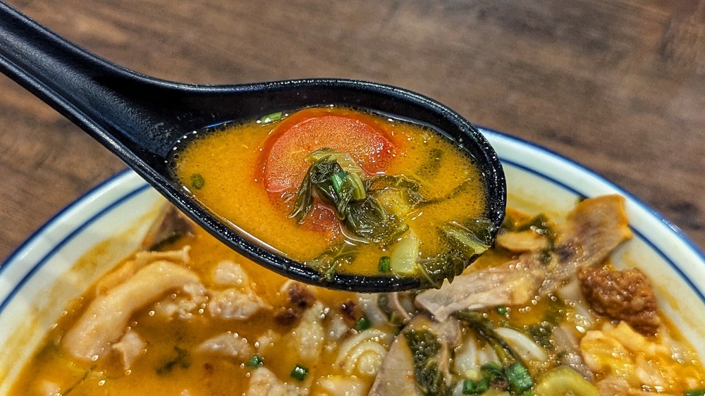 273245 The soup gets its trademark tang from lots and lots of pickled mustard greens and tomatoes. — Picture by Ethan Lau