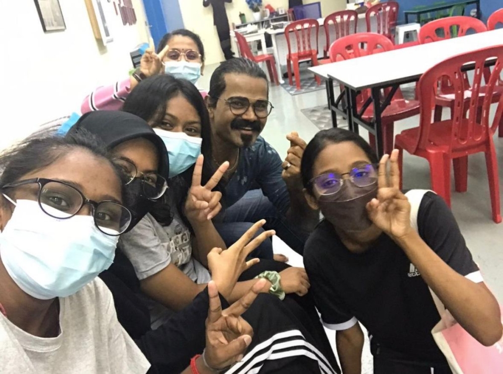 273530 Subash (with goatee) poses for a picture with some of his students at the tuition centre. — Picture courtesy of Subash Abdullah