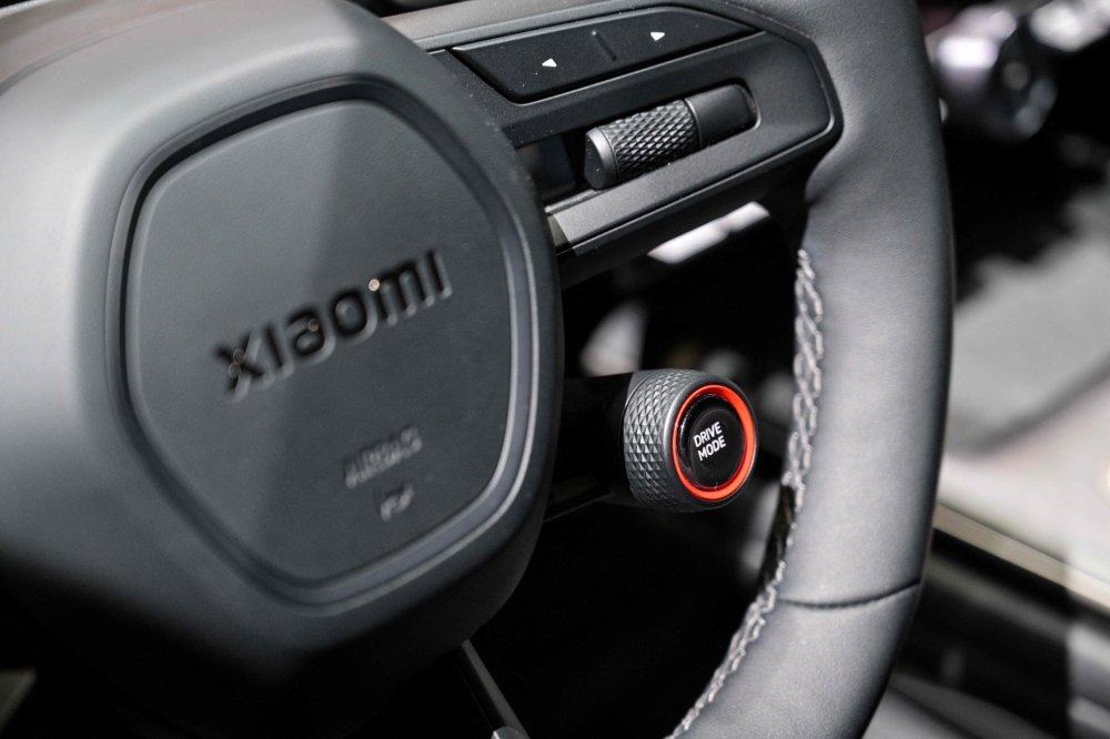 273826 A drive mode selector by the steering wheel of a Xiaomi SU7 model. Intelligent driving features are the new battleground in China’s merciless car market, with competition spurring brands to world-leading advances — but a recent fatal crash has seen the government intervene to put the brakes on runaway enthusiasm. — AFP pic