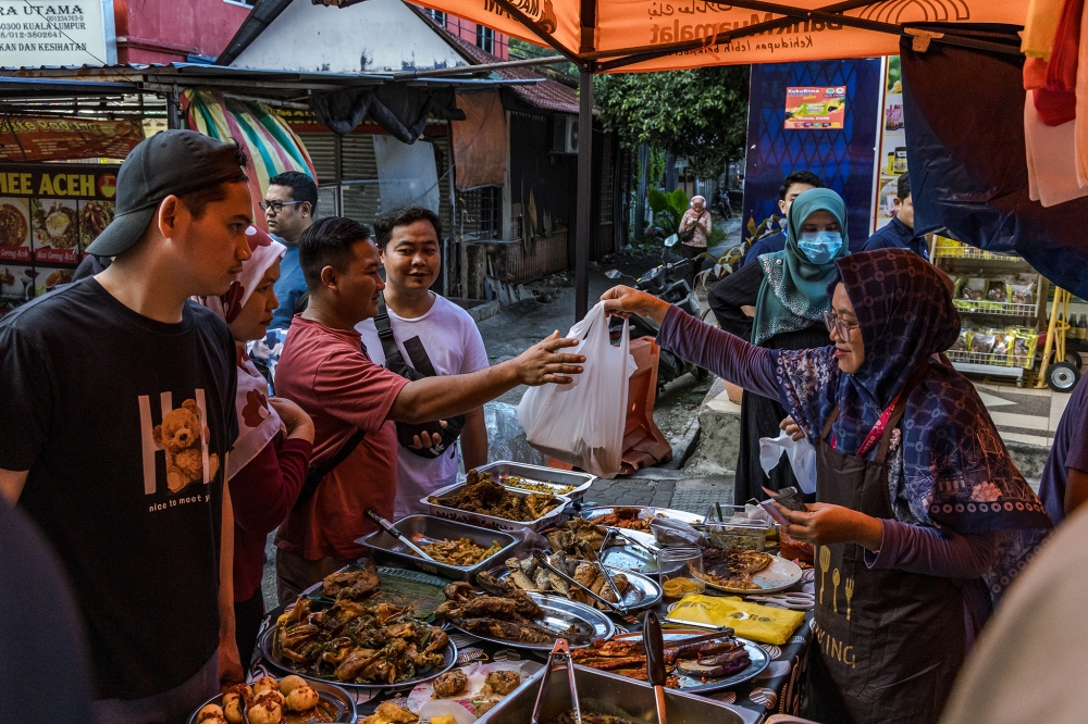 274471 Night markets offer opportunities to groups often excluded from the formal economy, such as single mothers and informal caregivers. — Picture by Firdaus Latif