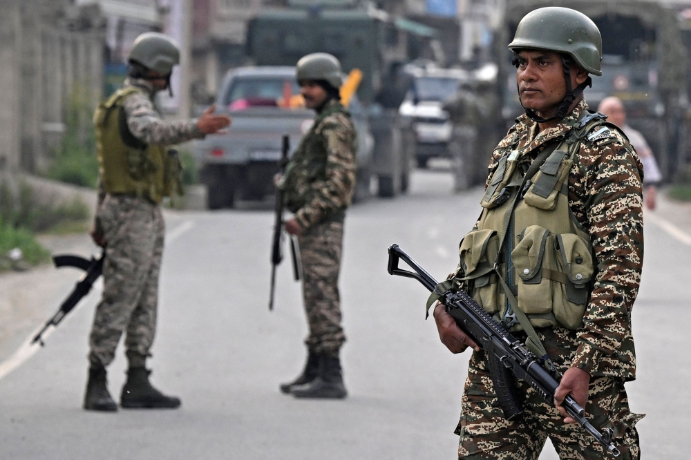 275540 Indian security personnel stand guard in Wuyan near Srinagar on May 7, 2025, following border tensions. — AFP pic