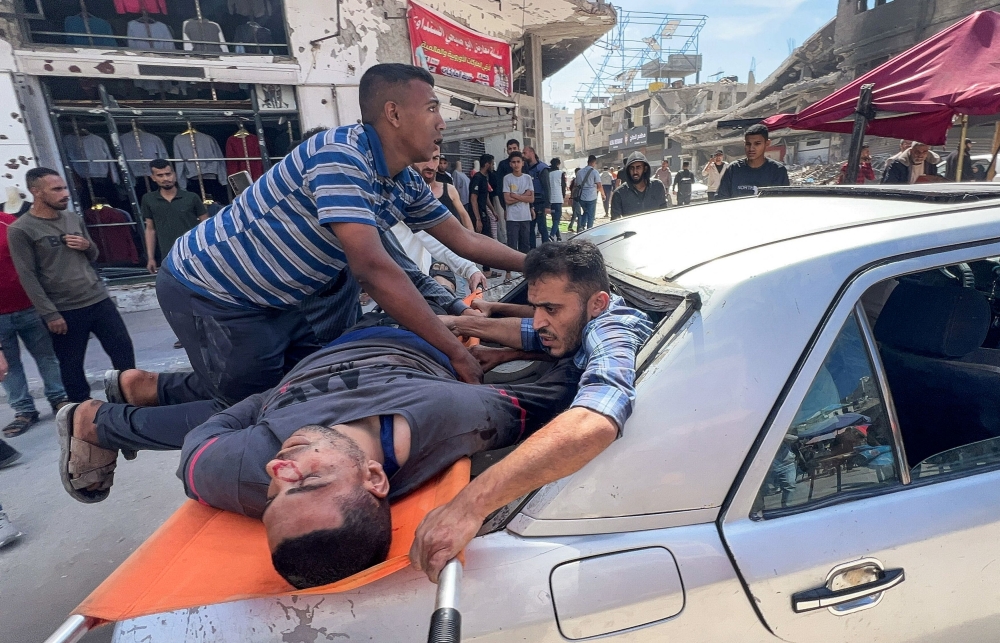 275696-1 Palestinians carry a victim after an Israeli airstrike, in Gaza City, May 7, 2025. According to the author, while India has condemned Hamas’s attack on October 7, 2023, and is concerned at the situation in Gaza, it has not condemned Israel’s genocidal attack on Gaza. — Reuters pic
