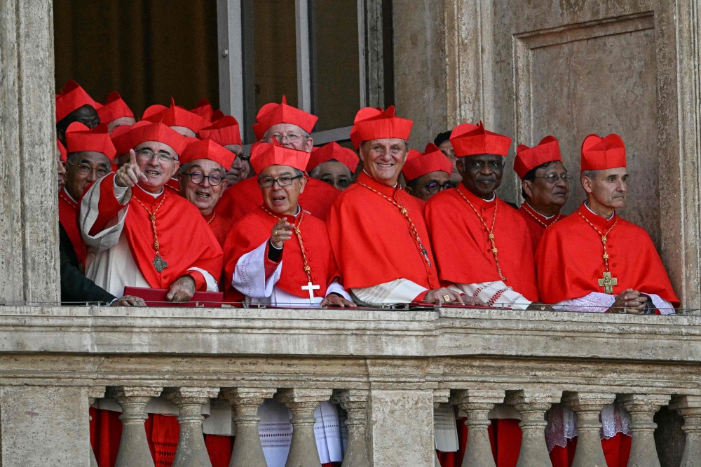 275844 Cardinals react from a balcony of the St Peter's Basilica, as the new pope makes his first appearance after the cardinals ended the conclave, in The Vatican, on May 8, 2025. — AFP pic