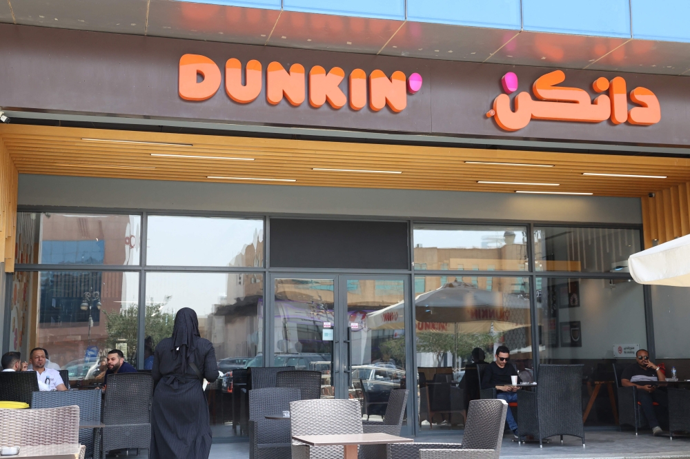 275927 Saudis and foreigners sit at Dunkin coffee shop in Riyadh on May 1, 2025. — AFP pic