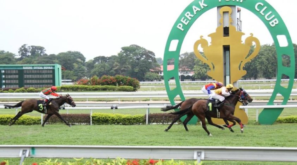 An undated photograph shows racehorses and their jockeys at the Perak Turf Club in Ipoh. — Picture courtesy of Perak Turf Club.