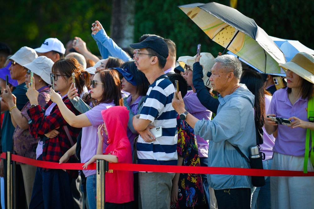 276166 Locals and tourists look on during the Changing of the Guard ceremony. — Bernama pic