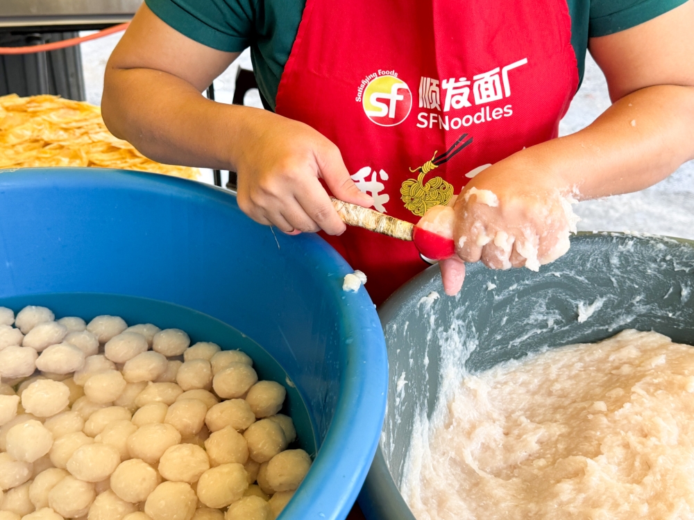276411 A lot of work goes into forming the fish balls by hand with a scoop to maintain consistency in the portion -- Picture by Lee Khang Yi