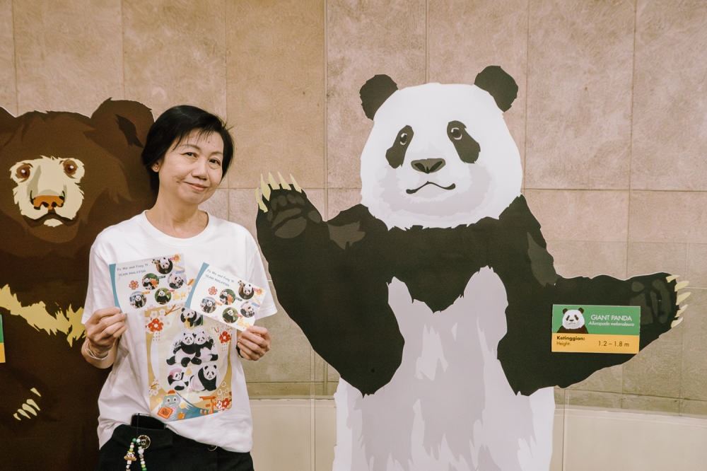 Some of the fan-made, panda-themed merchandise given out for free to visitors. — Picture by Raymond Manuel