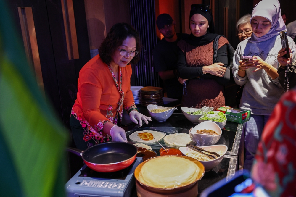 276916 Jennifer Lee Choo Neo (left), the Cultural and Social Committee Member of the Persatuan Peranakan Baba Nyonya Kuala Lumpur dan Selangor (PPBNKLS) prepares Nyonya ‘popiah’ during a Peranakan Chinese cooking demonstration for members of the media, held recently in conjunction with the Nyonya Heritage@The Saujana Hotel programme in Shah Alam, May 14, 2025. — Bernama pic