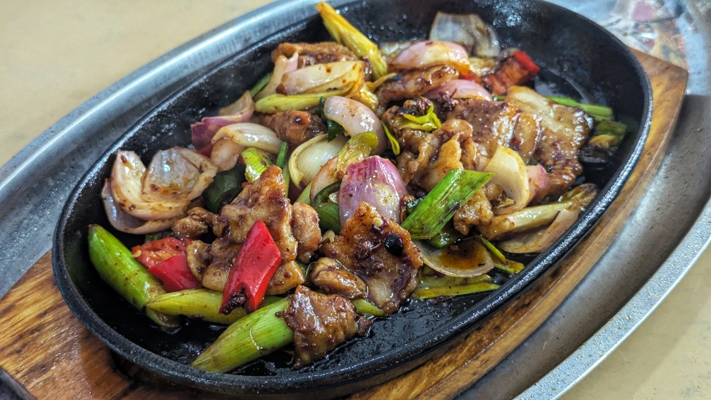 276972 Sichuan-style 'xiao chao rou' is as fragrant as it is bold and delicious, and is a hit with the regulars. — Picture by Ethan Lau