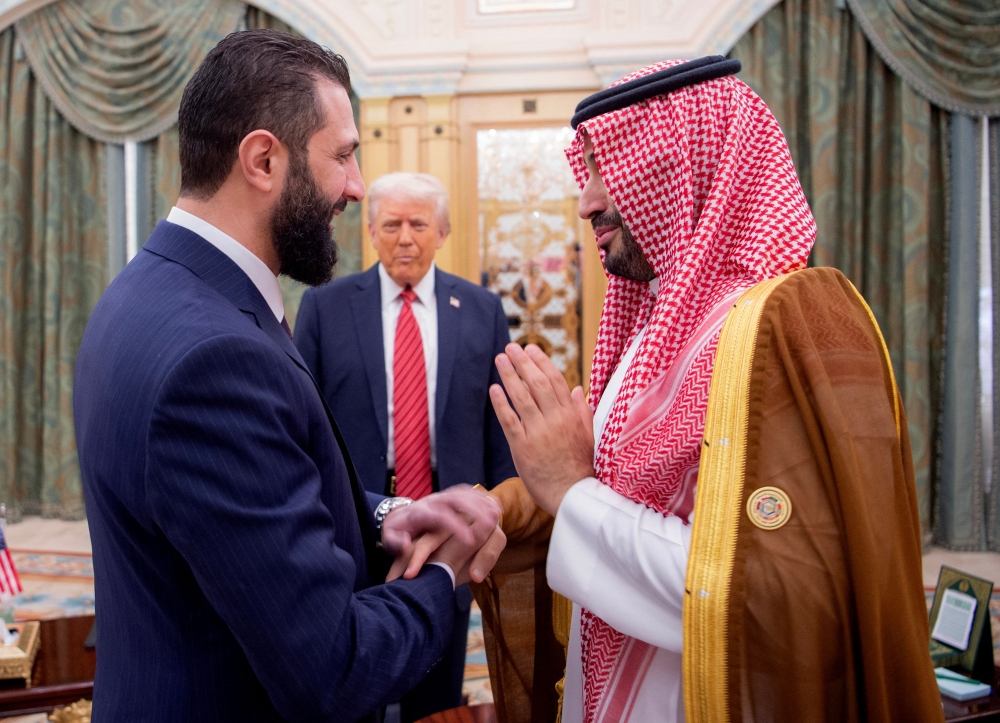 277146-1 Syrian President Ahmed al-Sharaa meets with US President Donald Trump and Saudi Crown Prince Mohammed Bin Salman in Riyadh, Saudi Arabia, in this handout released on May 14, 2025. — AFP pic/Saudi Royal Palace/Bandar Al-Jaloud