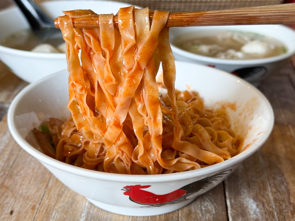 277161 Slick with that sweet, slightly spicy tomato chilli sauce, the broader ‘mee pok’ with its silkier bite is a hit with many. — Picture by Lee Khang Yi